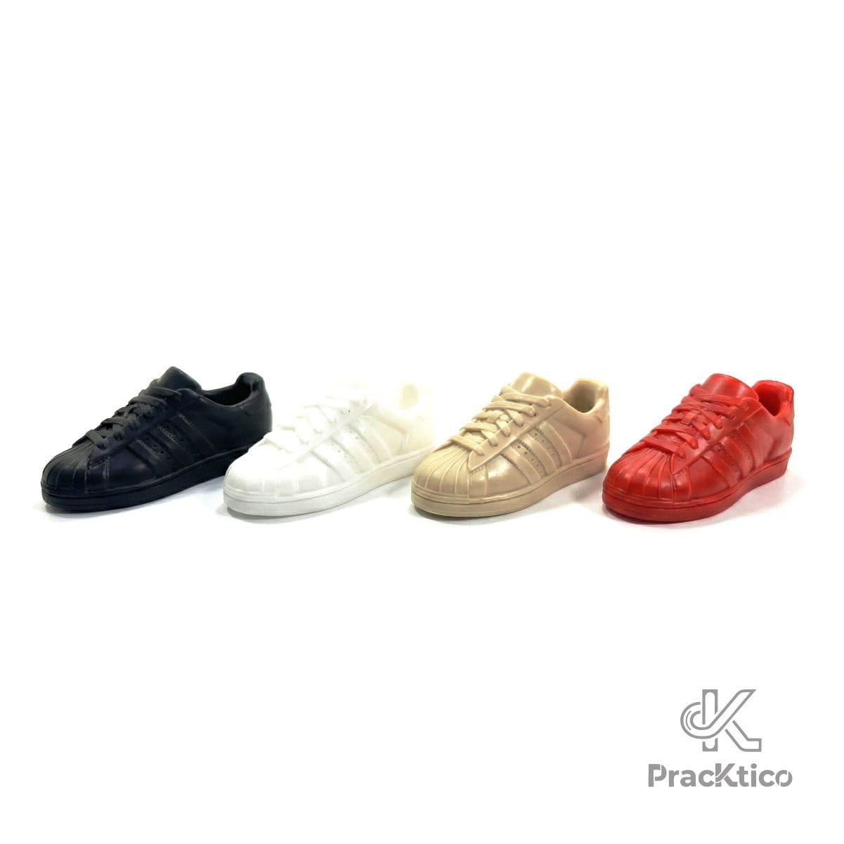 PisapapelesTenis2 Set de 4 pisapapeles magnéticos con forma de tenis colores negro, blanco, beige y rojo alineados en diagonal.
